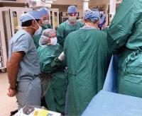 Dr. Muraszko in the OR with Sanjay Gupta during the filming of a CNN profile.